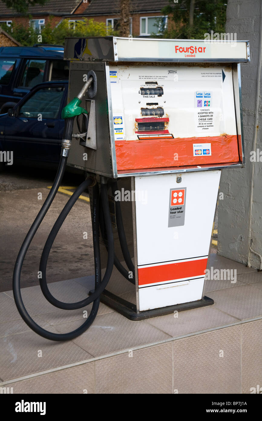 An old obsolete old four star pump / vintage 4 star petrol pumps at filling station garage forecourt. UK. Stock Photo