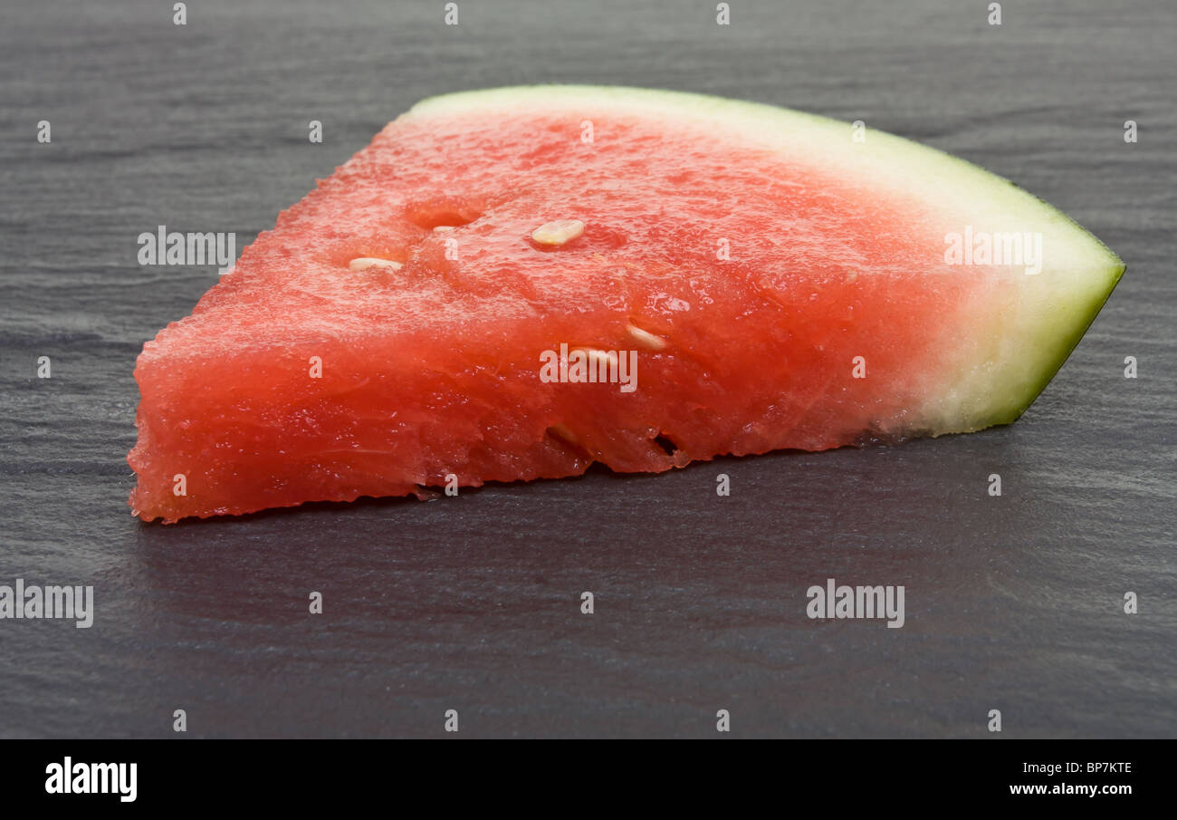 Abstract image of Watermelon segment against dark slate background. Stock Photo