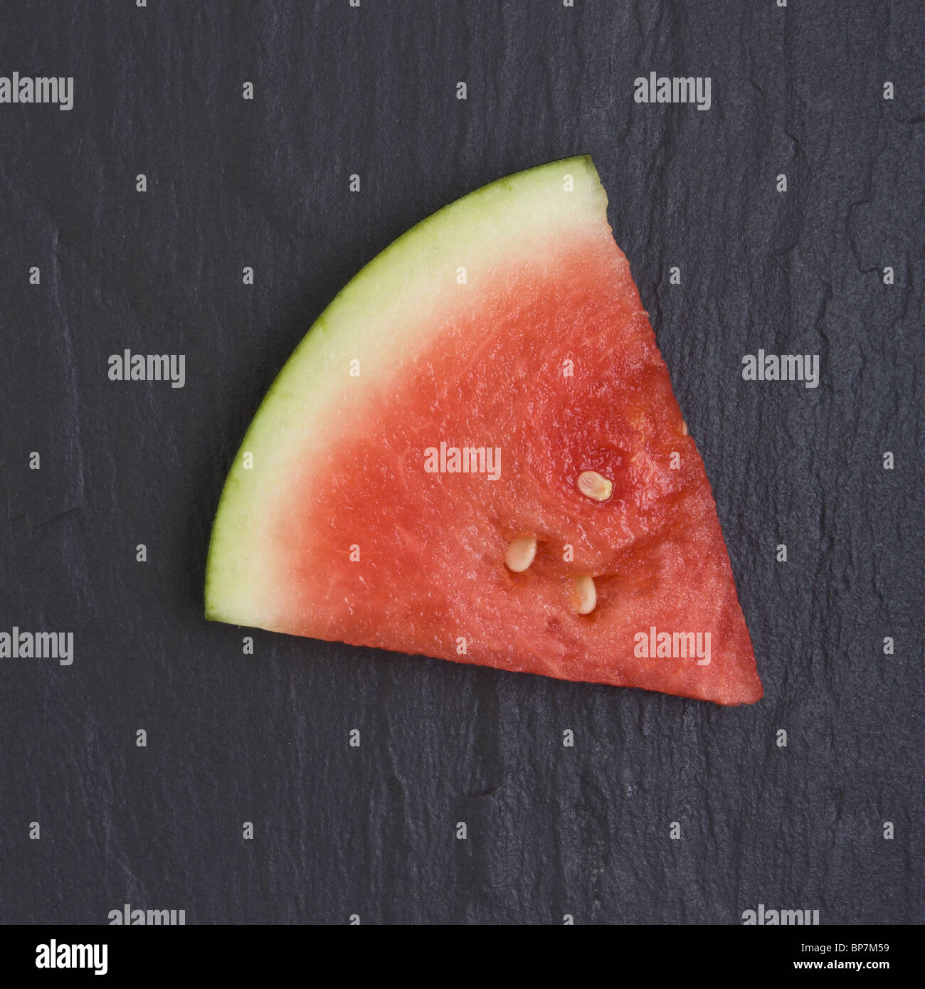 Abstract image of Watermelon segment against dark slate background. Stock Photo
