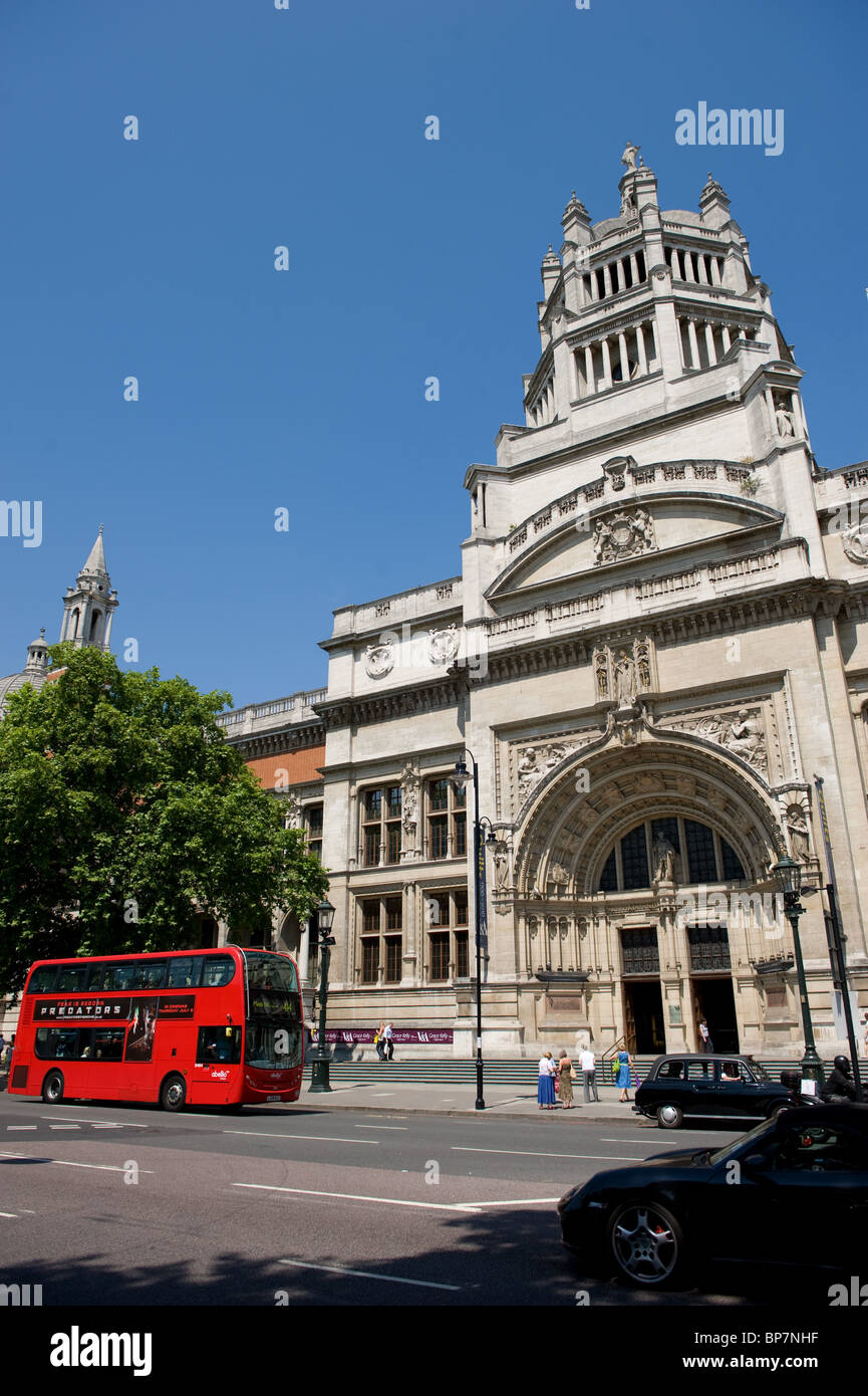 Exterior view of the V&A Museum London with blue sky and London double-decker bus in view, London UK Stock Photo