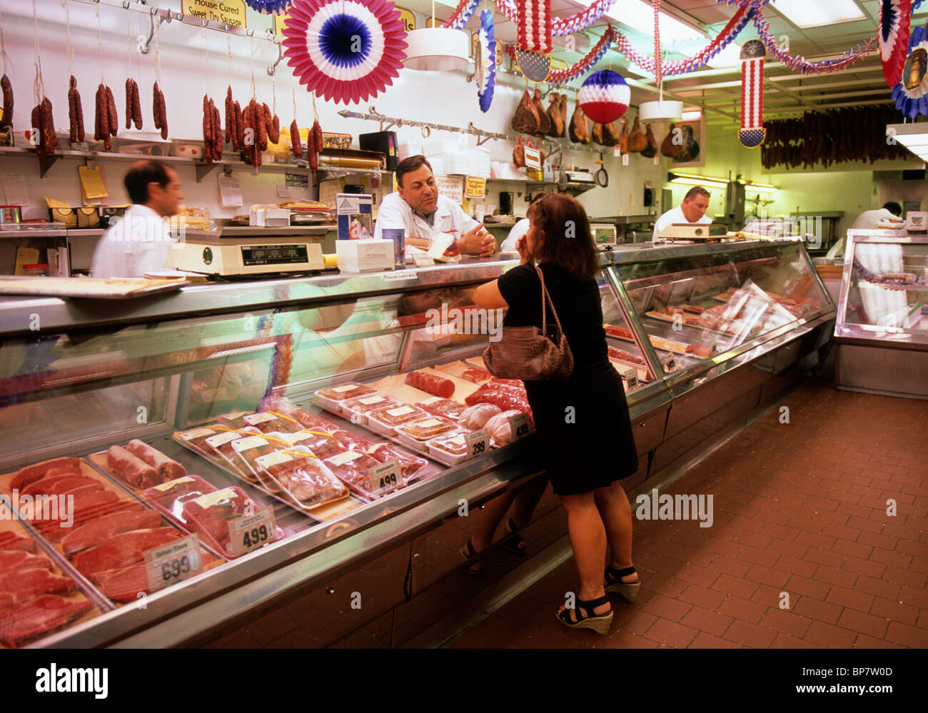 The Bronx, New York City Arthur Avenue. Woman at the meat counter at