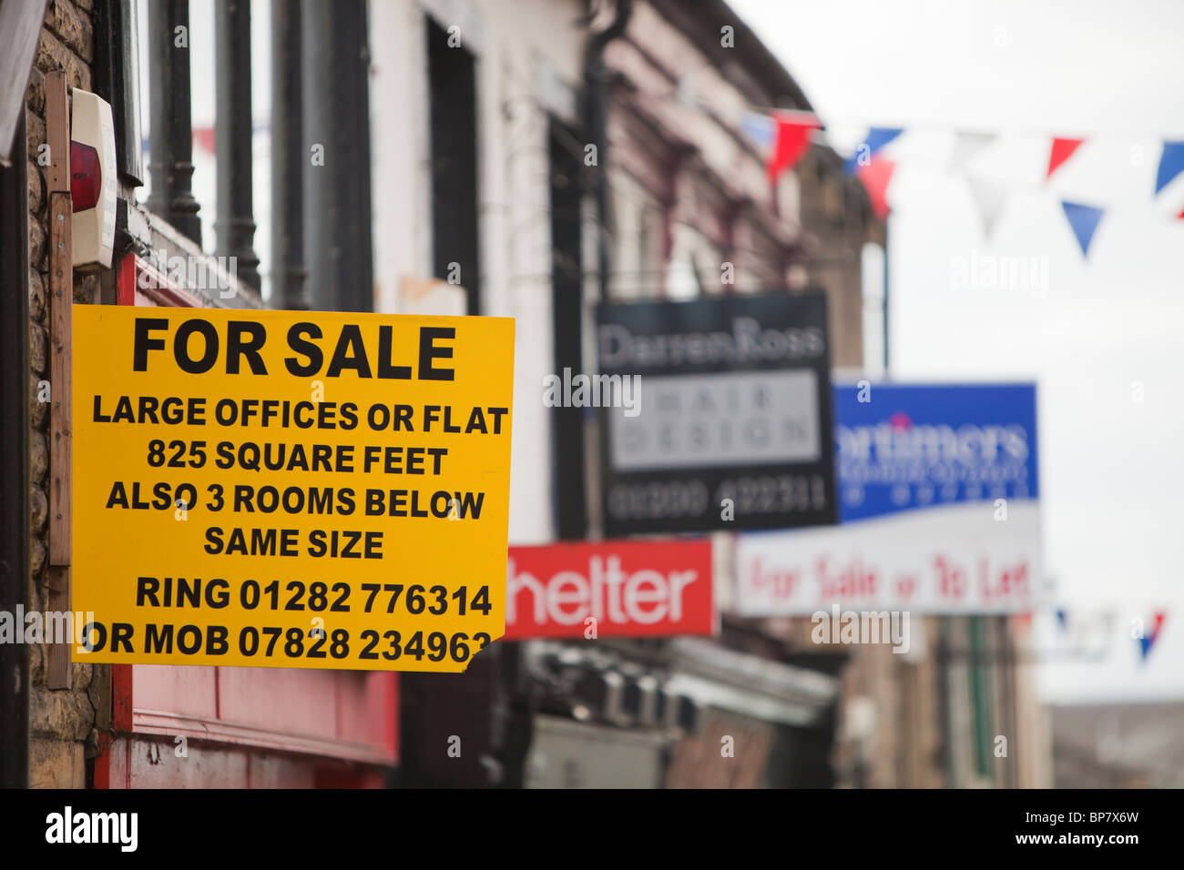 Shops for sale on the main street of Clitheore, Lancashire, UK, during the downturn in the economy. Stock Photo