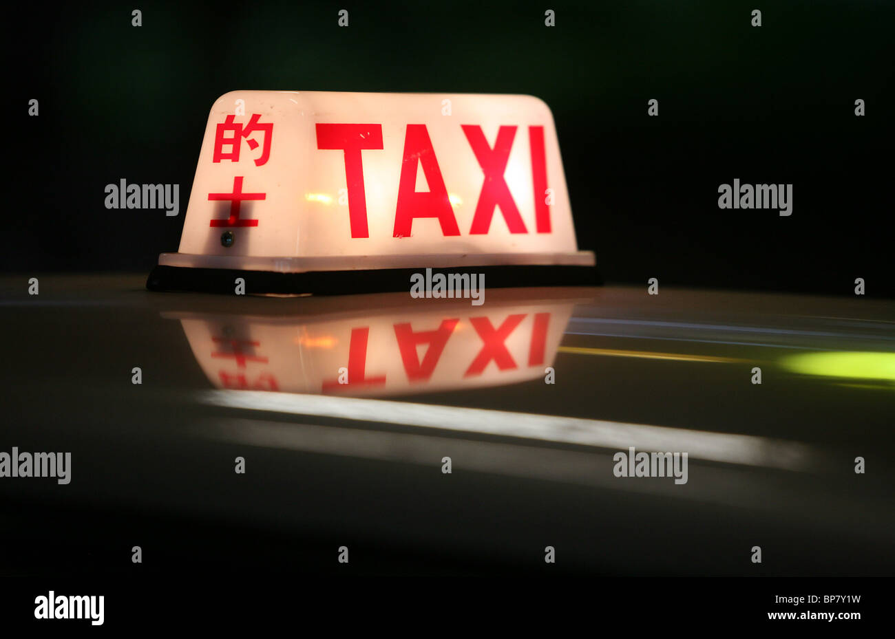 Illuminated taxi roof sign, Hong Kong, China Stock Photo