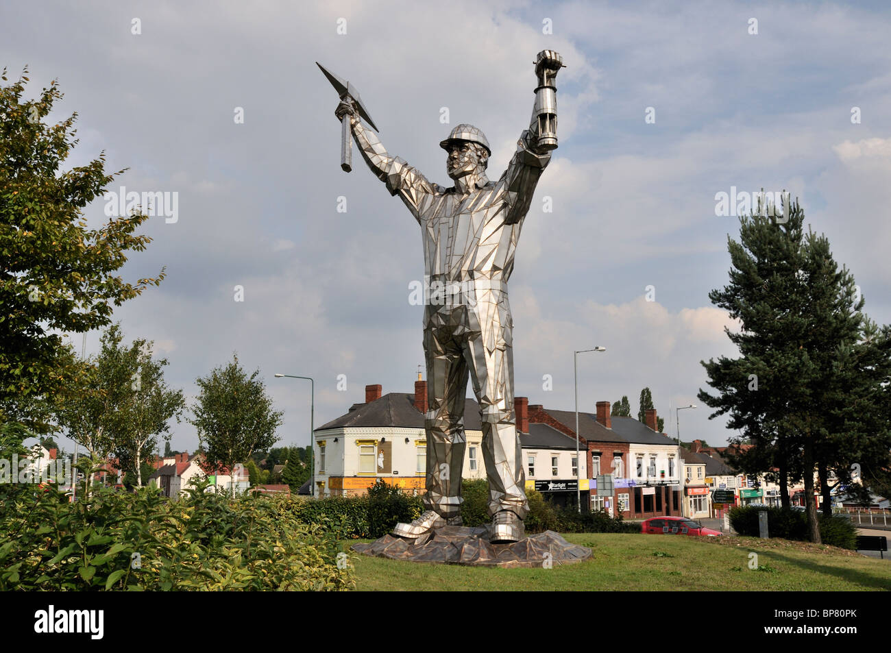 The Brownhills Miner designed and sculpted by John Mckenna and installed on a traffic island at a busy roads intersection Stock Photo