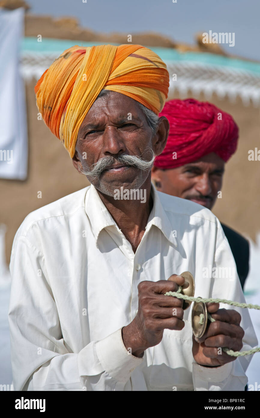 Indian man playing the manjira (small cymbals). Khuri village. Rajasthan. India Stock Photo