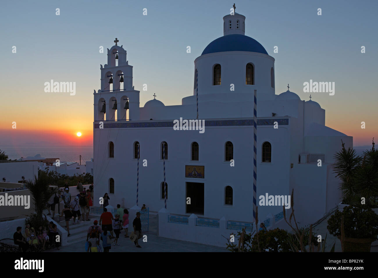 sunset behind a church in Oía, Santorini Island, Cyclades, Aegean Islands, Greece Stock Photo