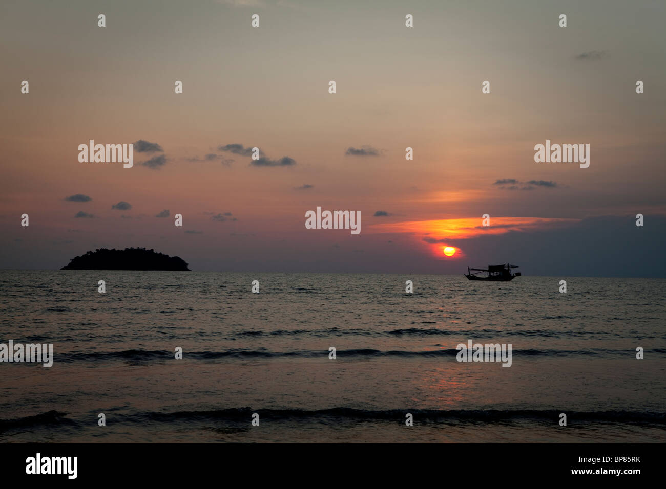 Fishing boat in sunset sky Stock Photo - Alamy