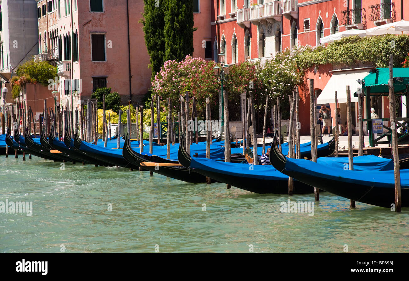 Gondolas moored by side of canal in Venice, Italy Stock Photo