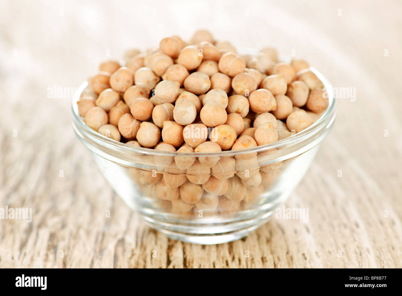 Dry raw organic chickpeas in small glass bowl Stock Photo