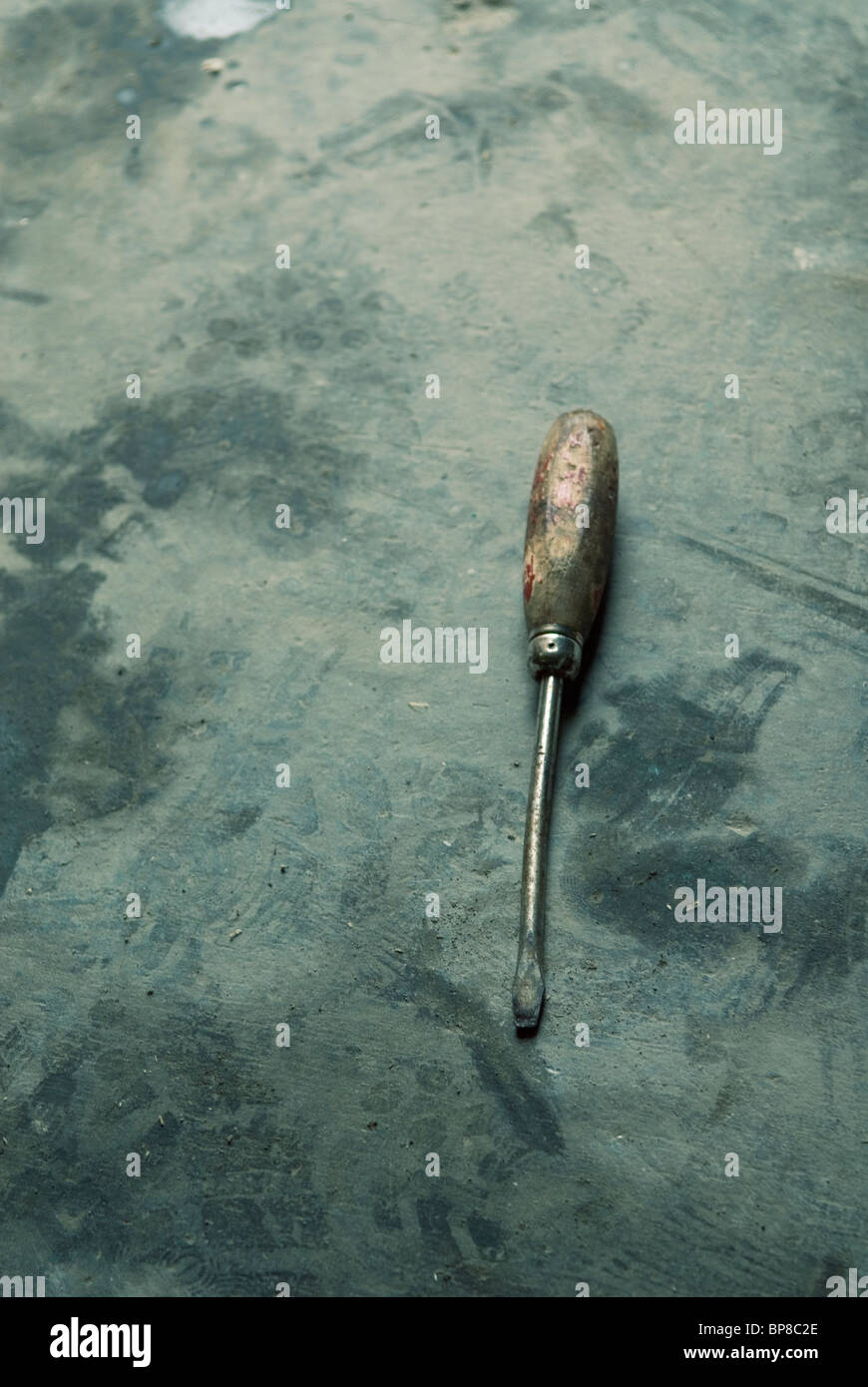 Old screwdriver forsook on the floor Stock Photo