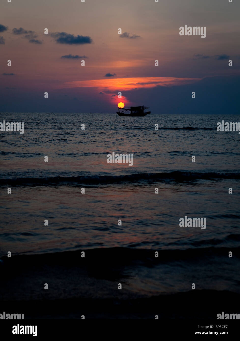 Fishing boat in sunset sky Stock Photo - Alamy