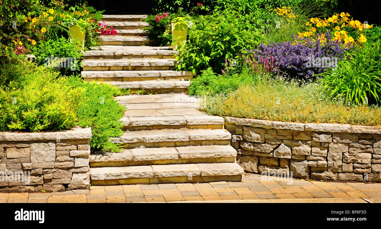 Natural stone landscaping in home garden with stairs Stock Photo
