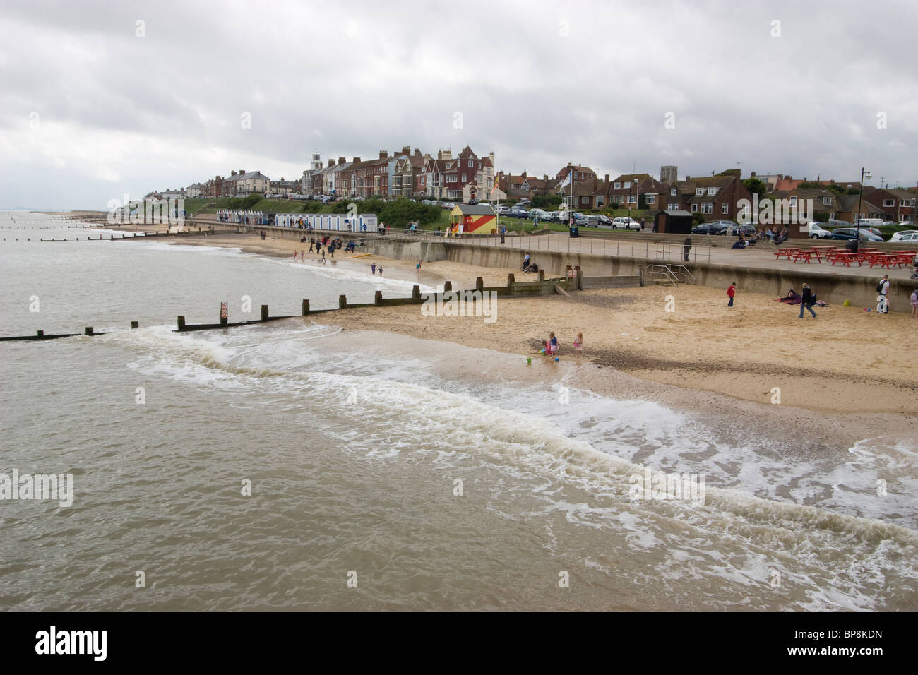 Southwold Beach, Suffolk, with bathers enjoying the seaside and the charming town of Southwold visible in the background, Suffolk Stock Photo