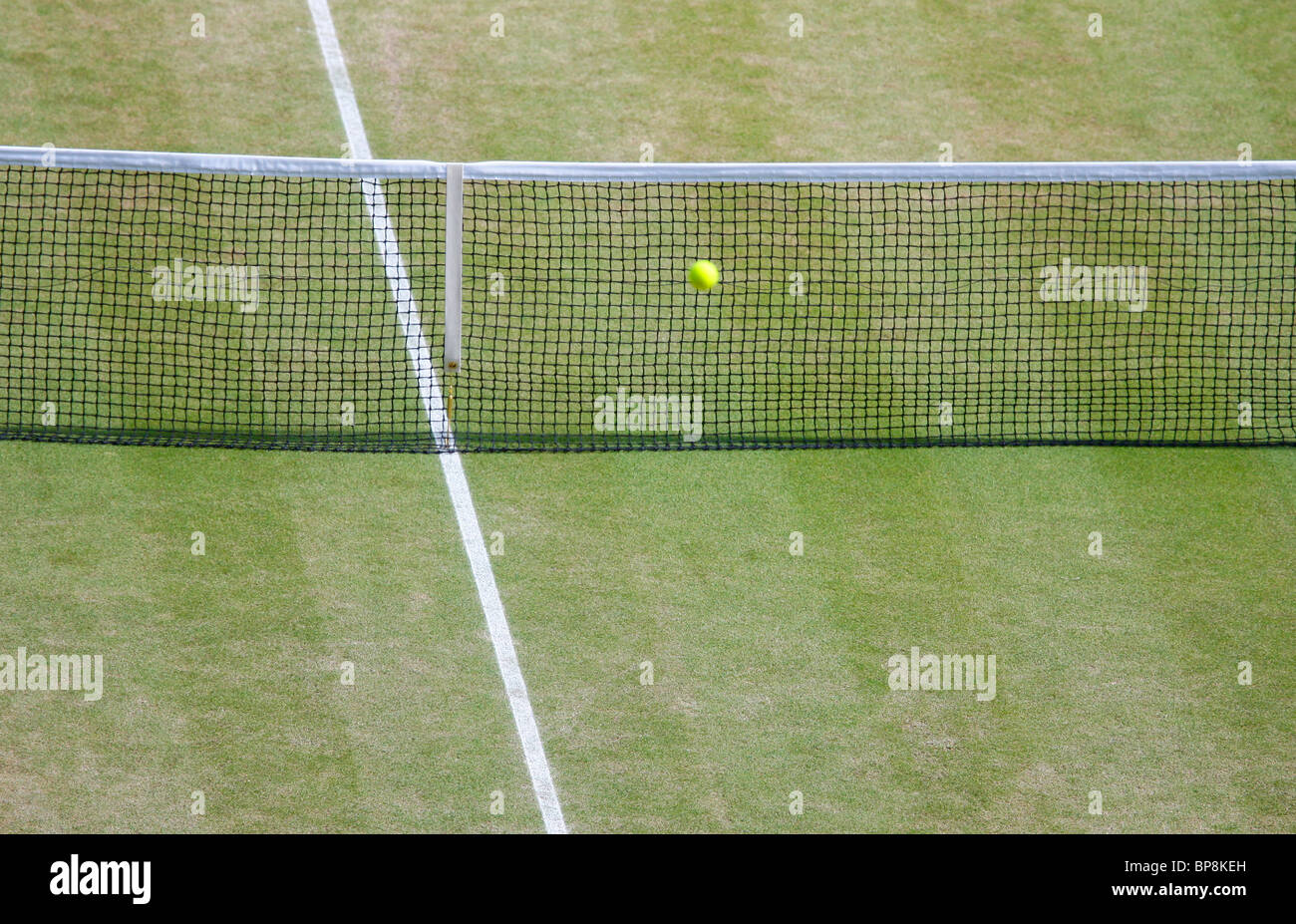 View from above of a ball going into the net on the empty Wimbledon Centre Court Stock Photo