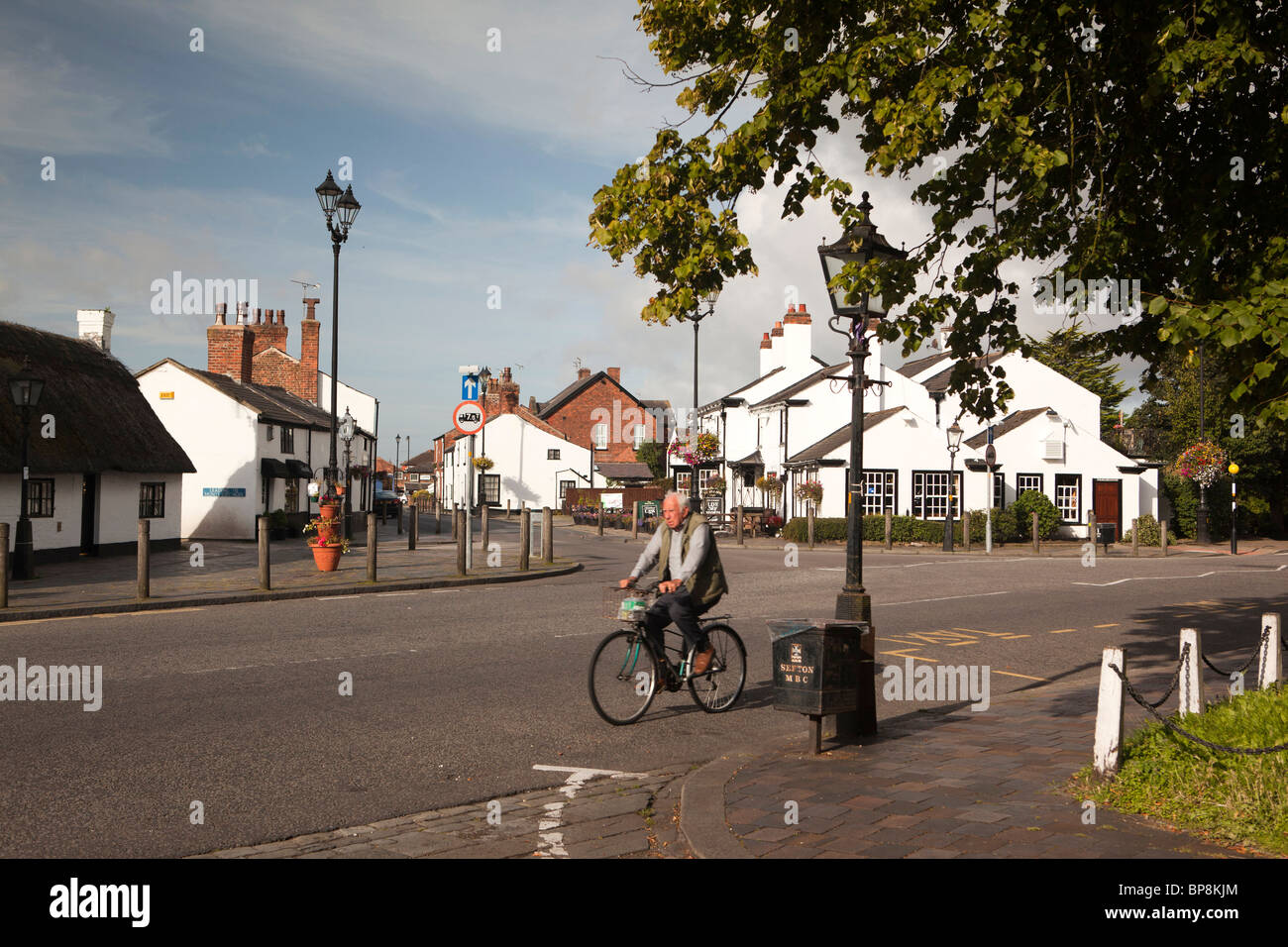 UK, England, Merseyside, Southport, Churchtown, man cycling along Botanic Road Stock Photo