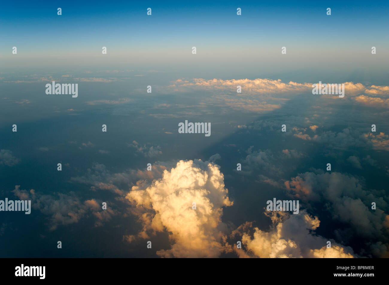 33,000 feet up over Europe low sun casting long cloud shadows Stock Photo