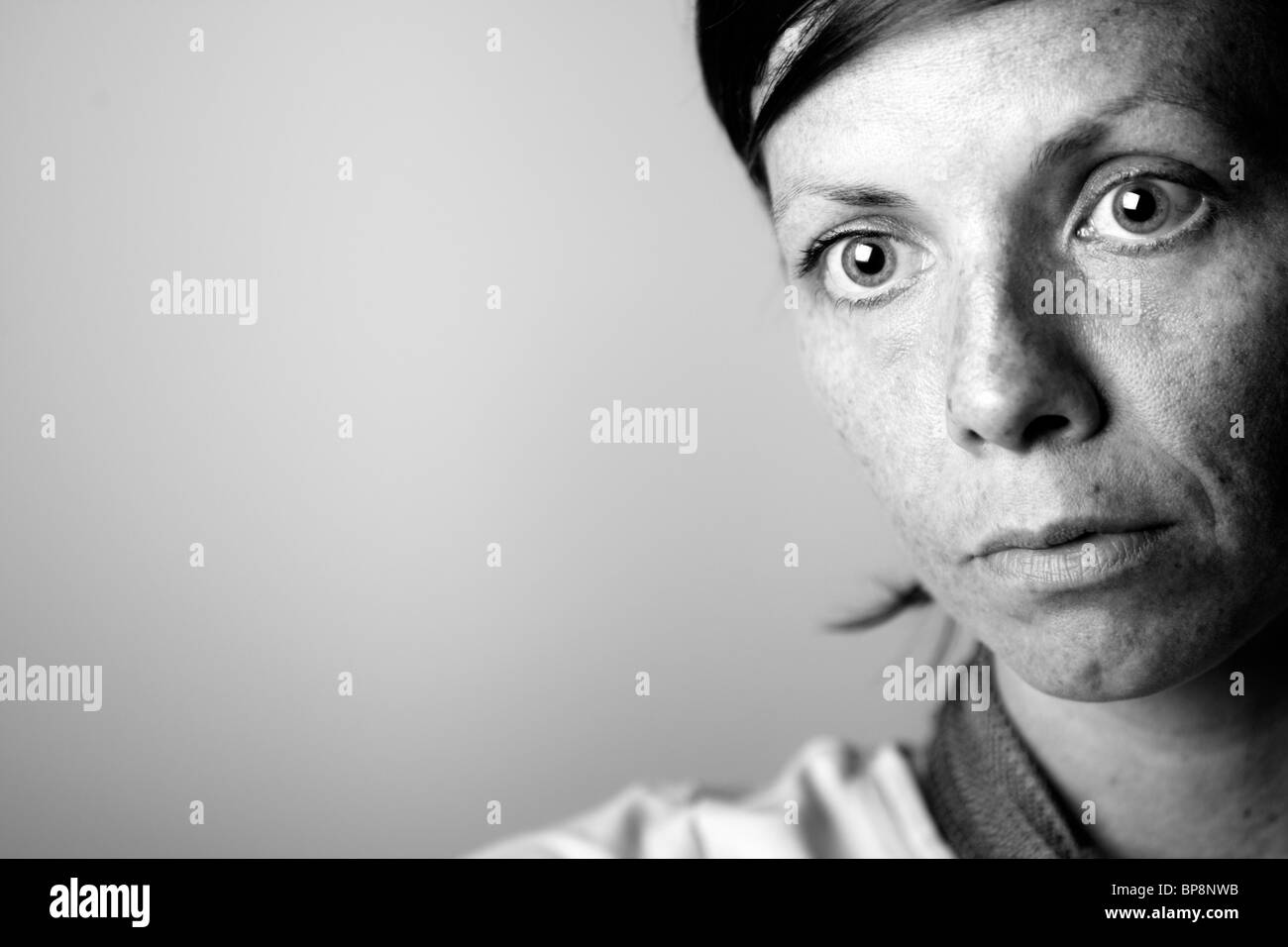 Black and White Shot of a Pensive Middle Aged Woman Stock Photo