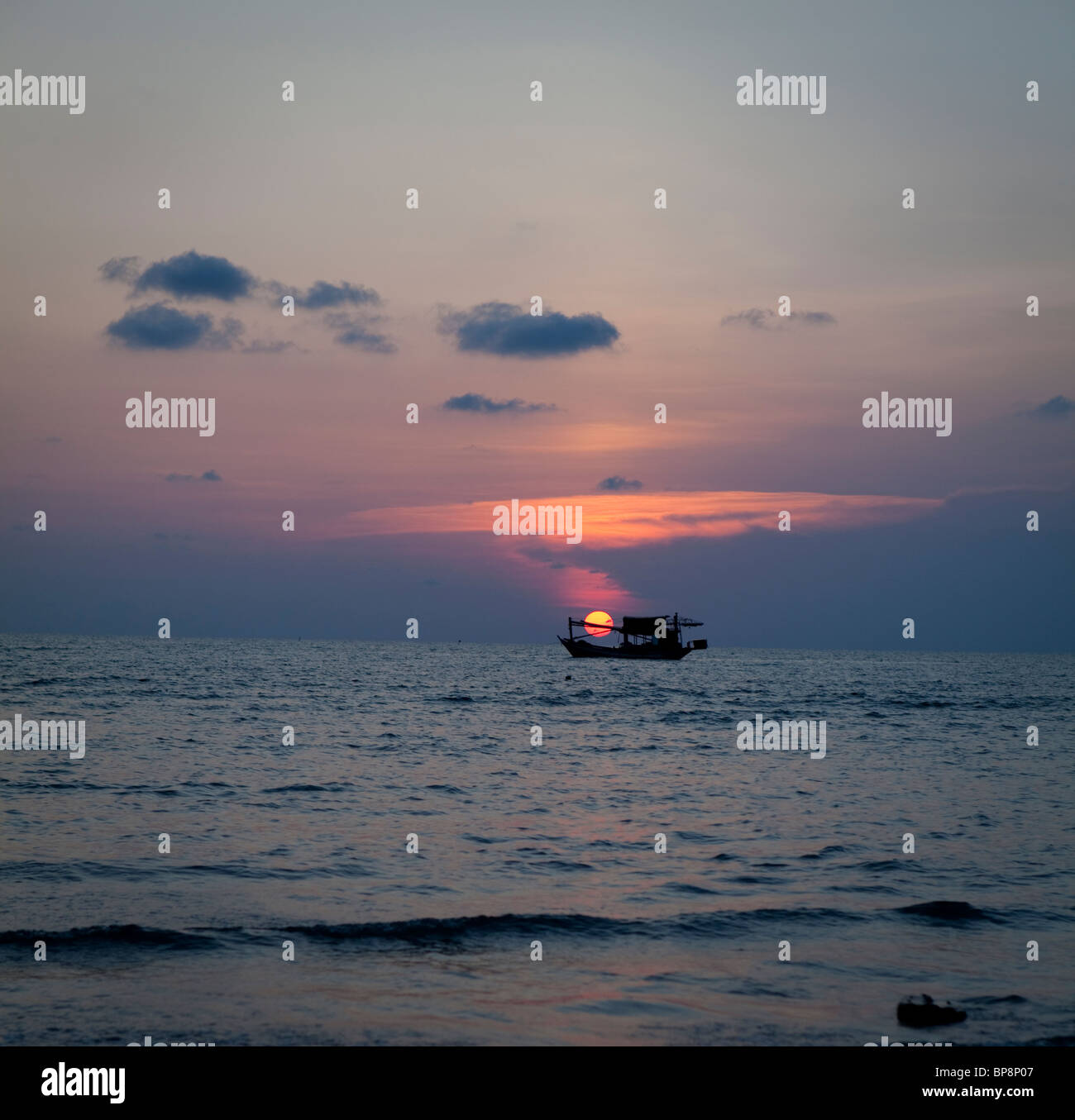 Fishing boat in sunset sky Stock Photo - Alamy