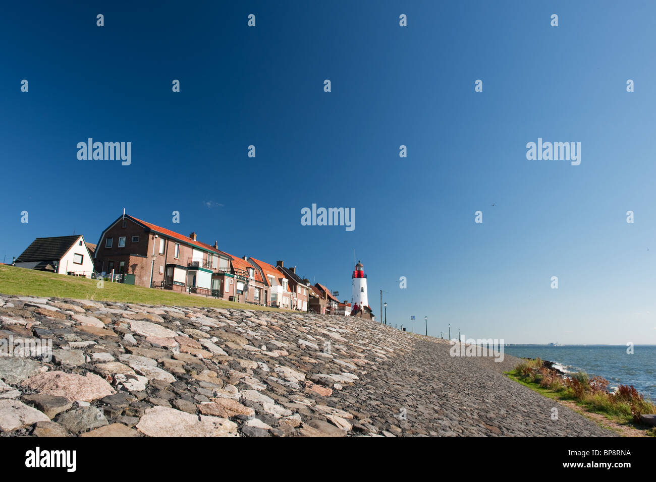 White lighthouse in little Dutch fishing village Urk Stock Photo