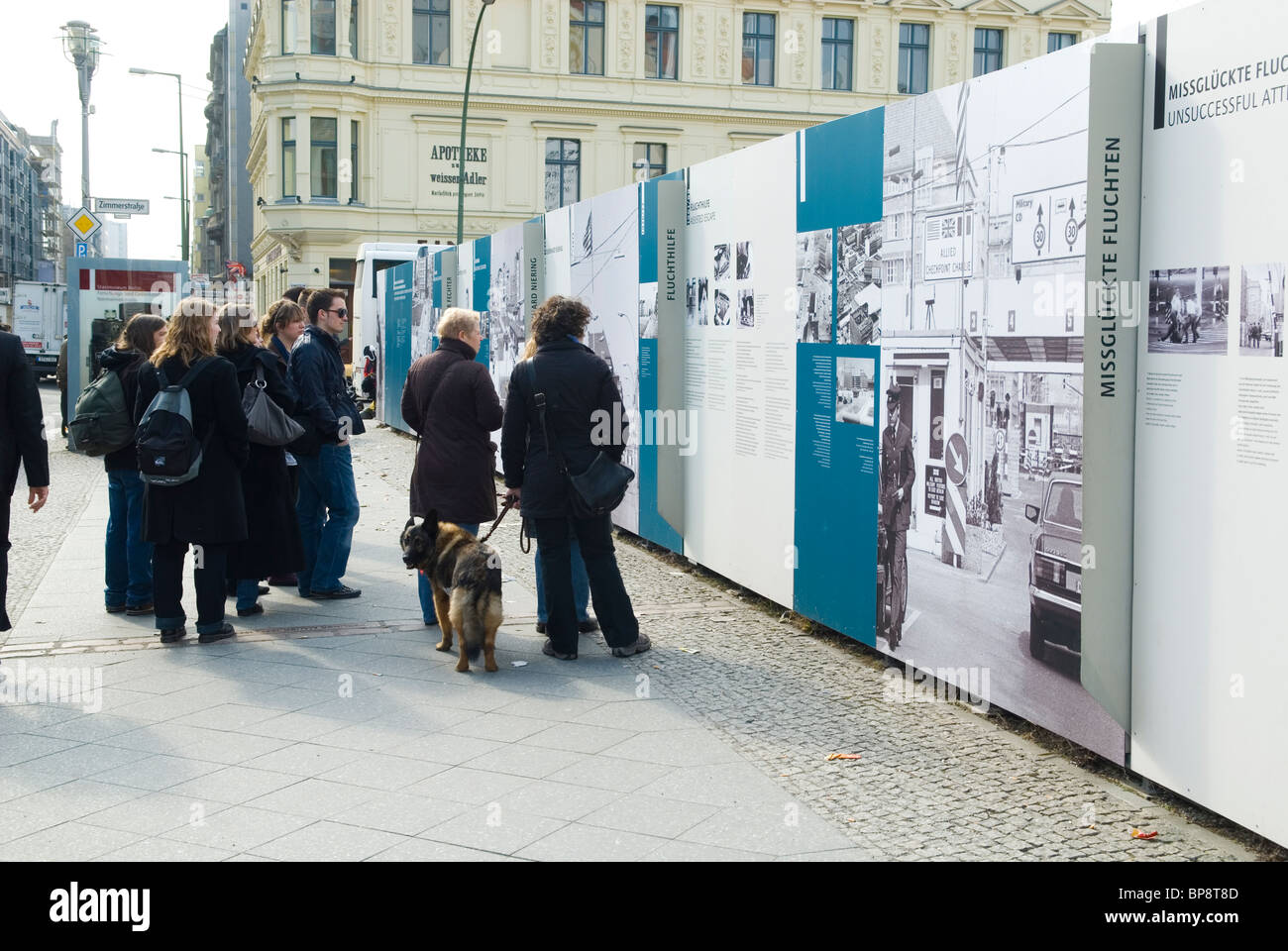 Tourist watching an outdoor photo gallery at Checkpoint Charlie Berlin Germany Stock Photo
