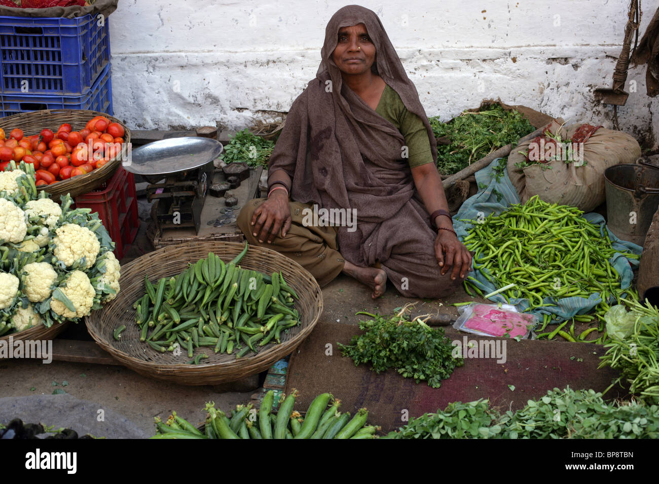 Woman selling vegetables in street market, Ujjain, Madhya Pradesh