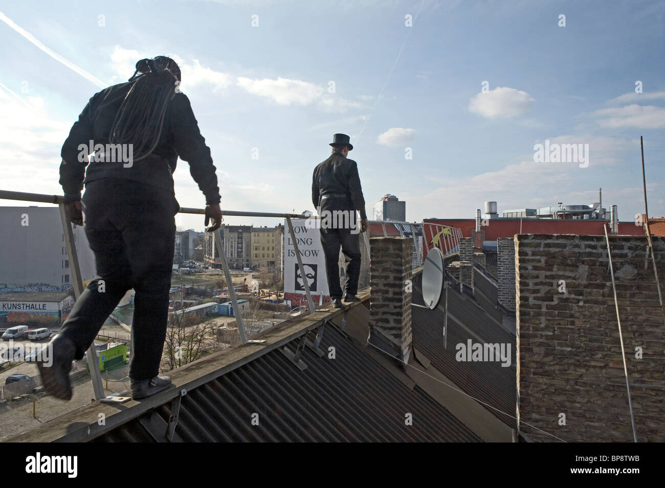 Chimney sweep on corrugated iron roof, Berlin, Germany Stock Photo