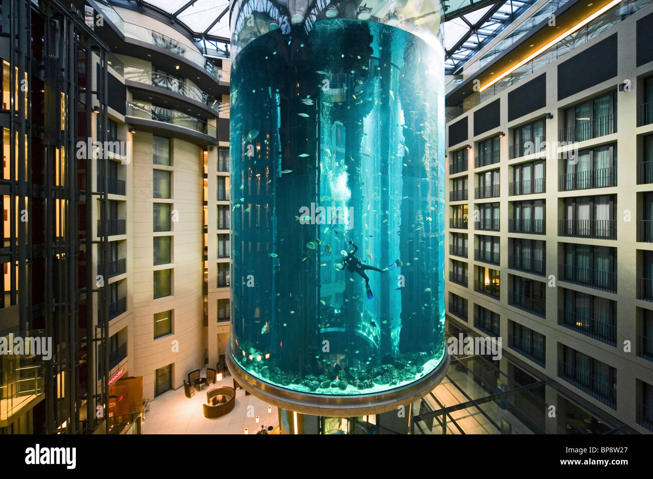 the 5 star Radisson SAS Hotel features the world's largest cylindrical aquarium. entrance to Aqua Dom, a diver cleans the tank, Stock Photo