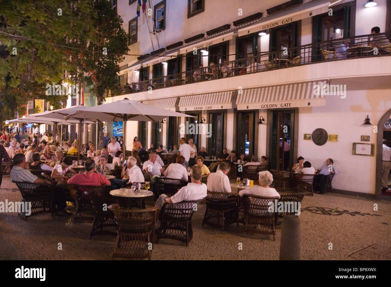 People sitting outside the Golden Gate Grand Cafe in the evening, Funchal, Madeira, Portugal Stock Photo