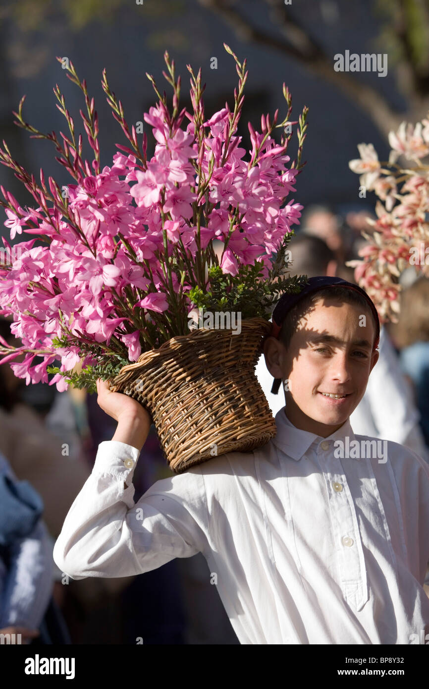 Young man with flower basket at the Madeira Flower Festival, Funchal, Madeira, Portugal Stock Photo