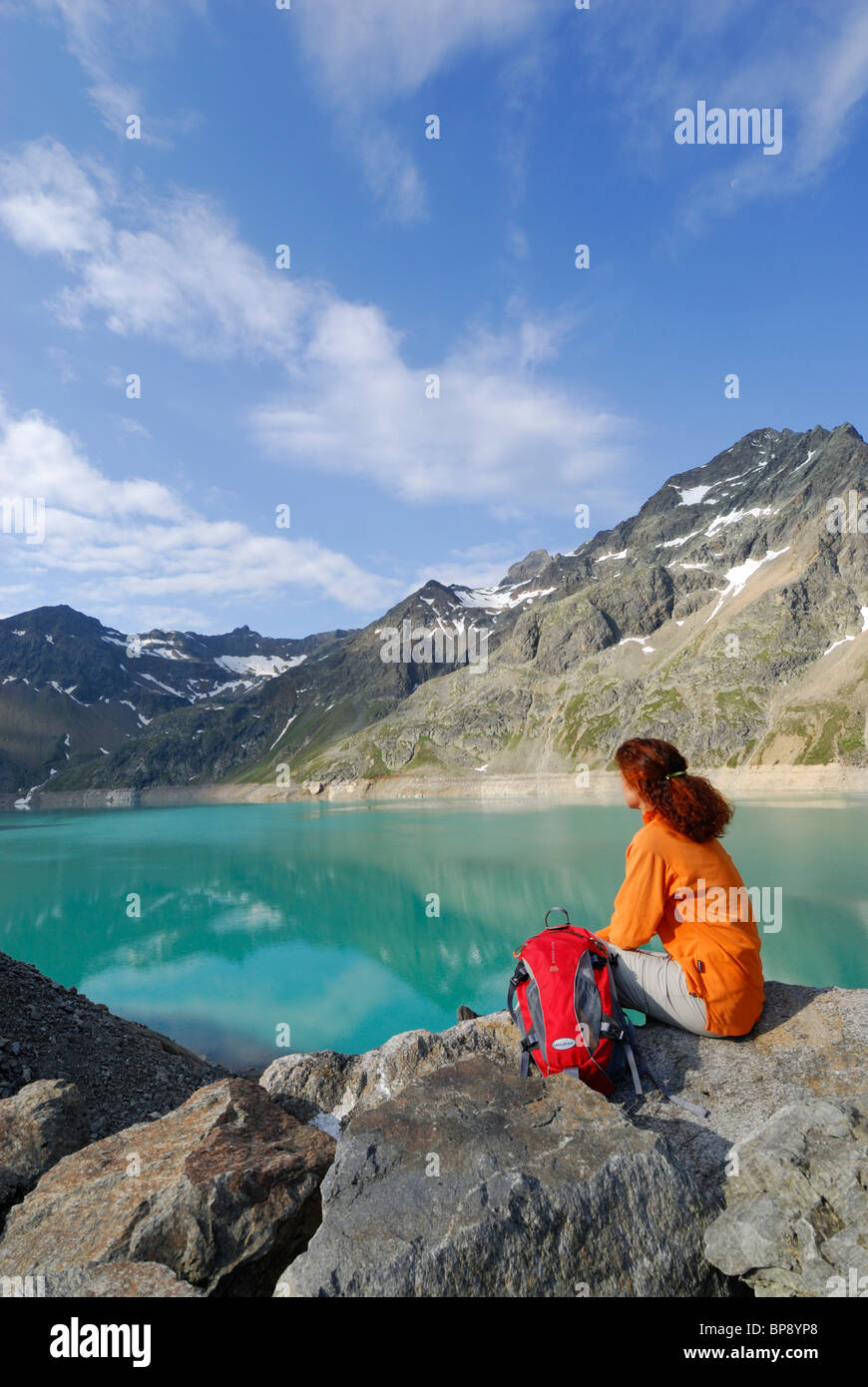 Woman looking over reservoir Finstertal, Sellrain, Stubai Alps, Tyrol, Austria Stock Photo
