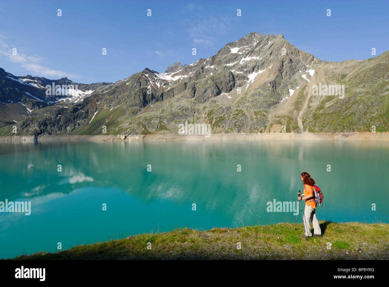 Female hiker at Finstertal reservoir, Sellrain, Stubai Alps, Tyrol, Austria Stock Photo