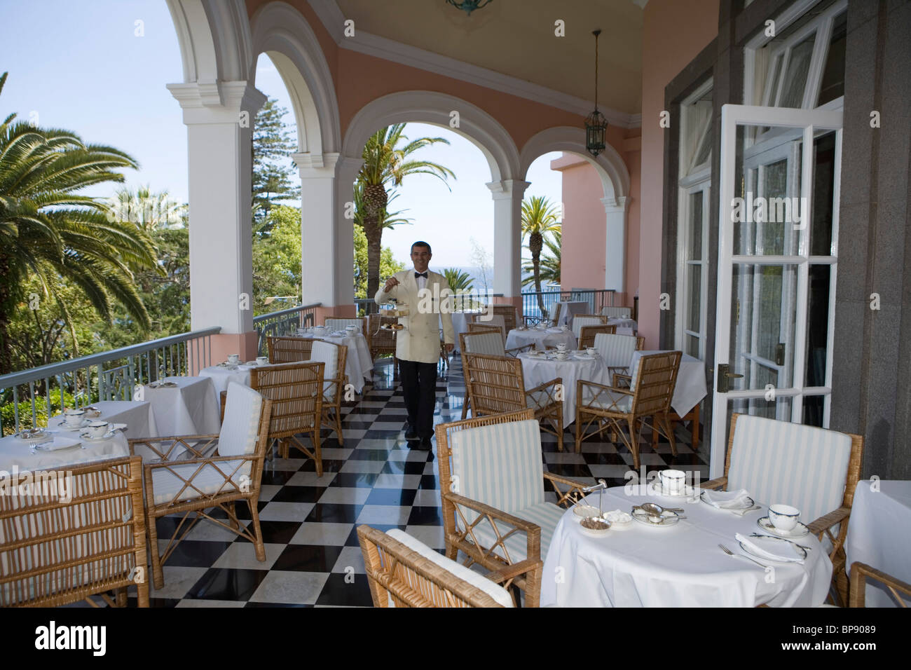 Waiter serves Afternoon Tea on the Terrace at Reid's Palace Hotel