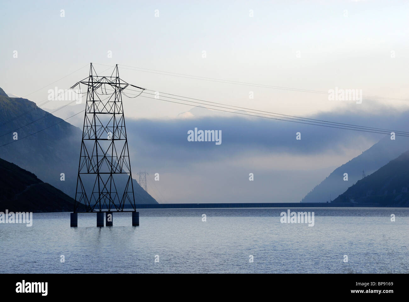 Electricity pylon in reservoir Lai da Sontga Maria, Lukmanier Pass, Adula Alps, Grisons, Switzerland Stock Photo