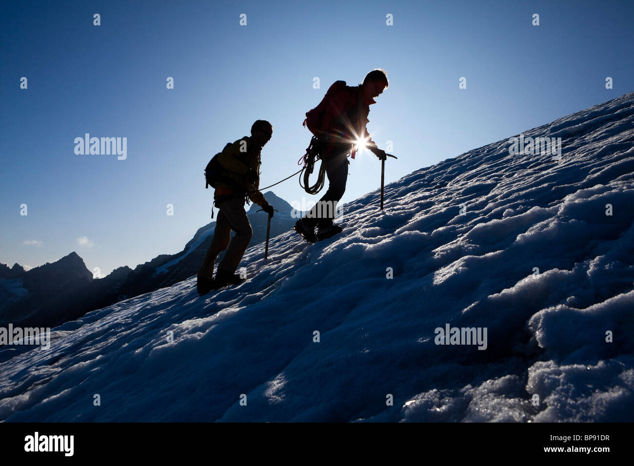Two mountaineers ascending over icefield, Clariden, Canton of Uri, Switzerland Stock Photo