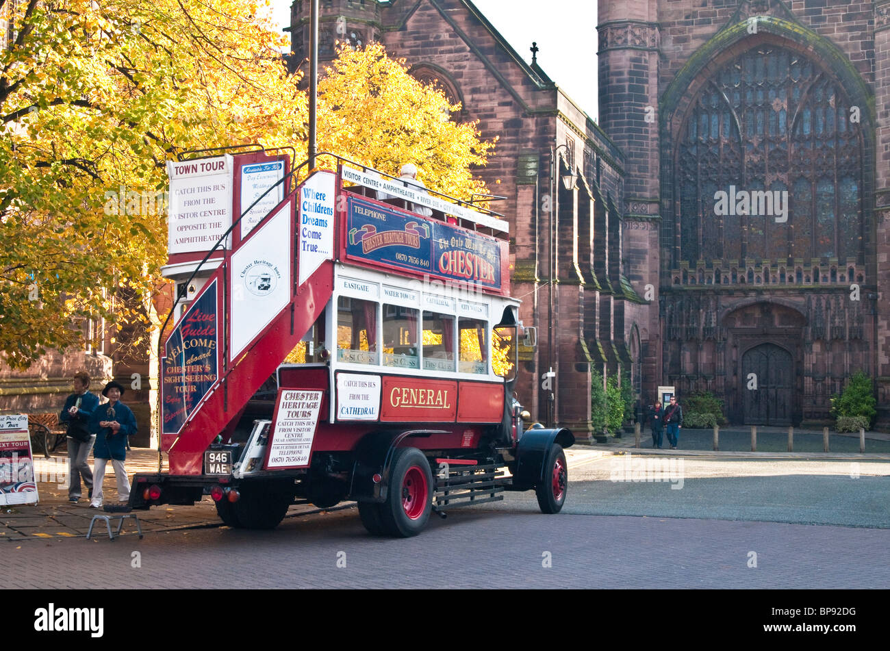 Vintager Motor Bus For taking tourists and visitors around Chester with a peep of Chester Cathedral in the background. Stock Photo