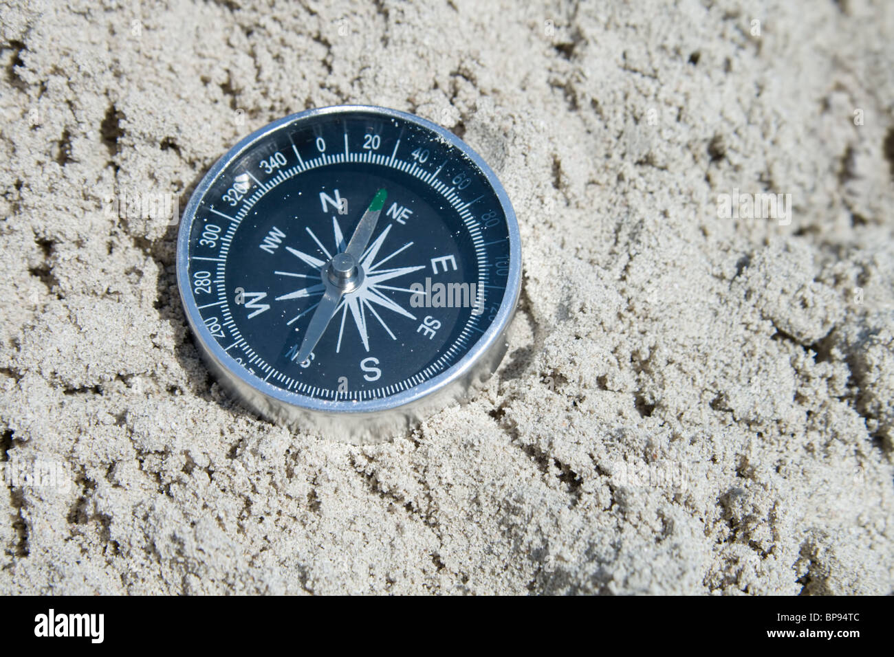 Compass in the sand Stock Photo