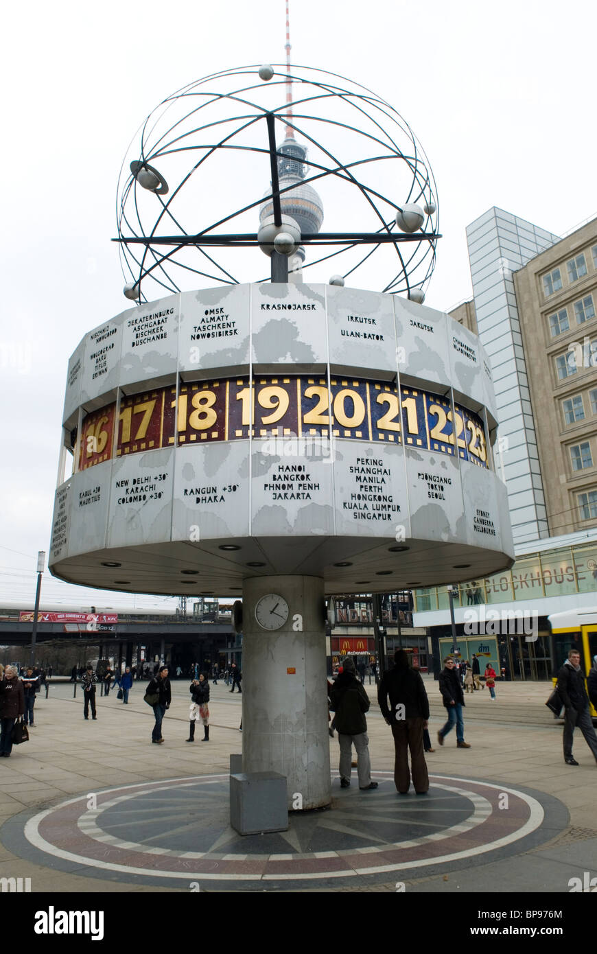 People at the world time clock Alexanderplatz Berlin city Germany Stock
