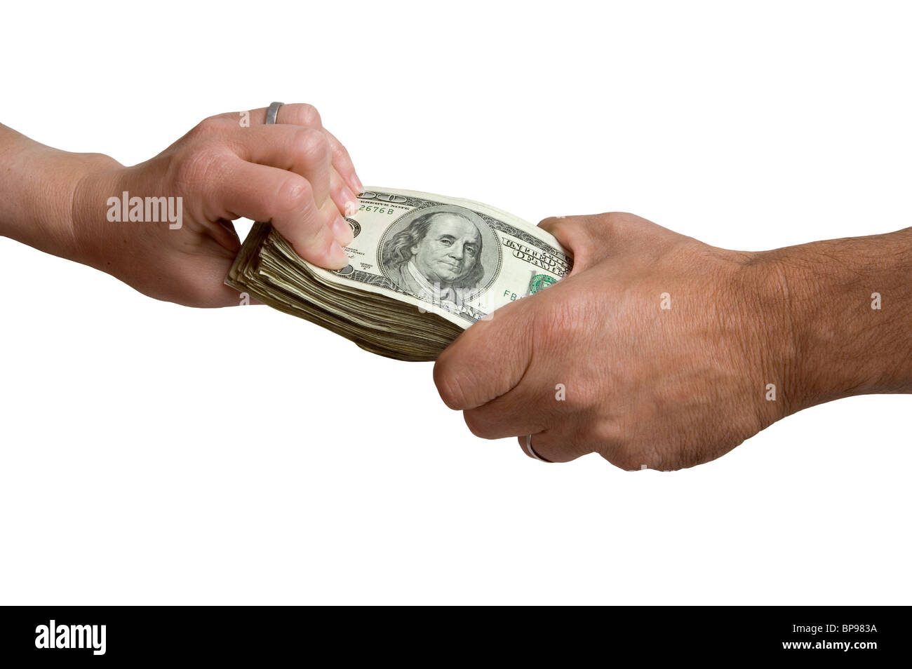 A man's and woman's hand each grasping at a stack of cash. Stock Photo