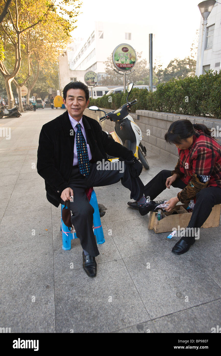 China, Suzhou. Getting a shoe shine. Stock Photo