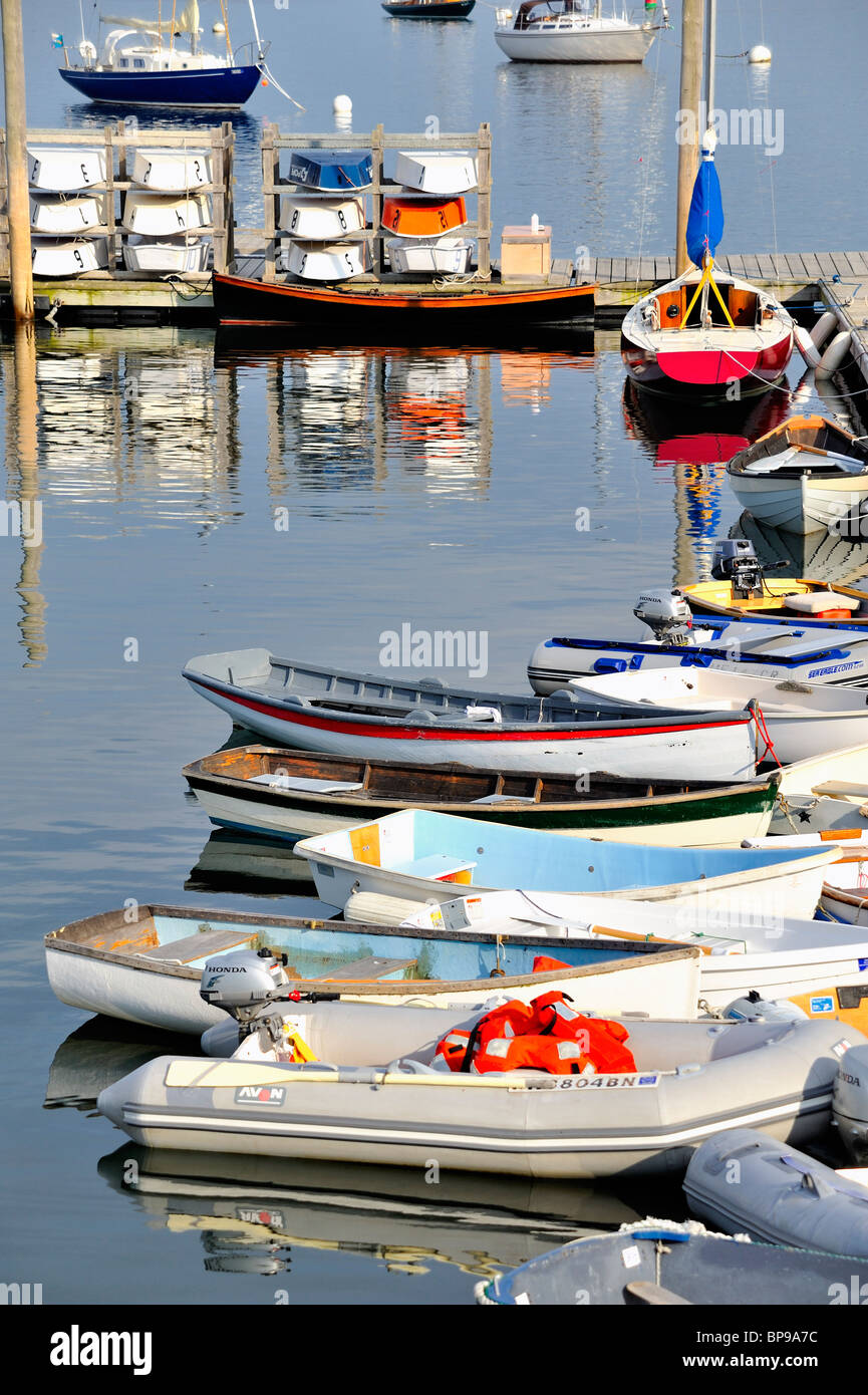Rockland Harbor Maine with colorful boats skiffs dinghies sailboats moored to pier dock quay vertical Stock Photo