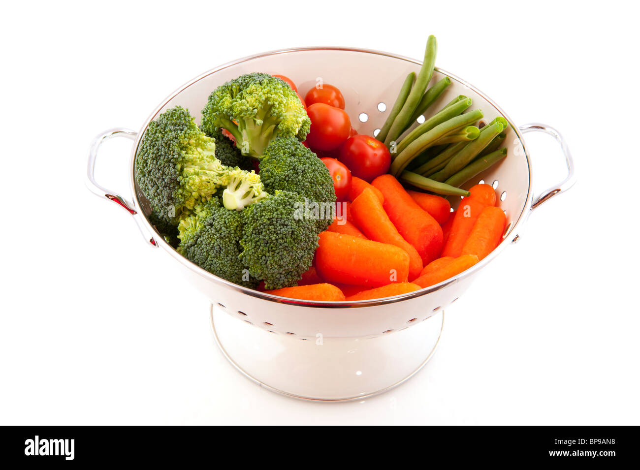 white colander with a diversity of fresh vegetables Stock Photo - Alamy
