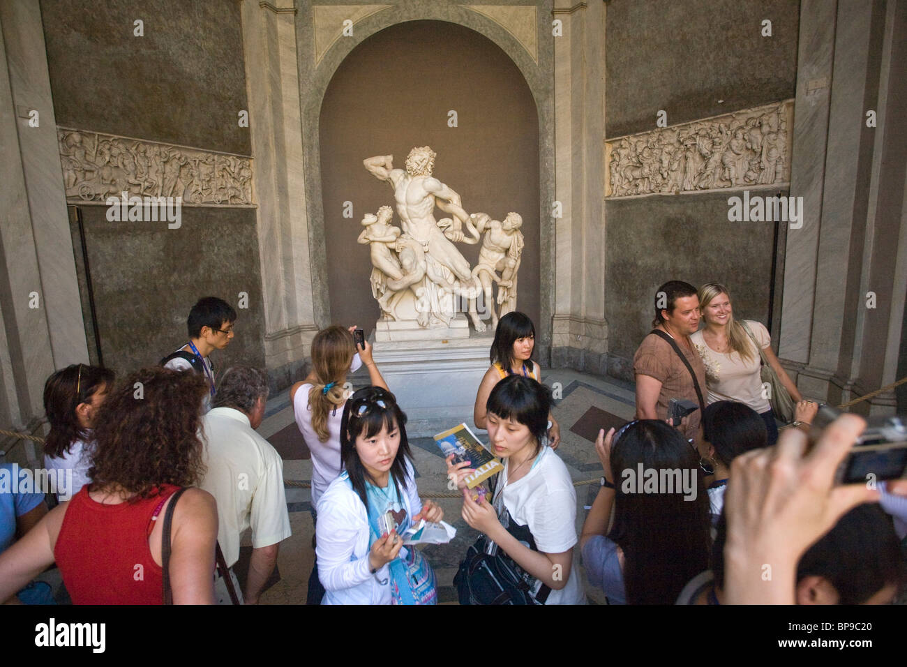 Tourists taking photos of the statue of Laocoon and His Sons, Vatican City Stock Photo
