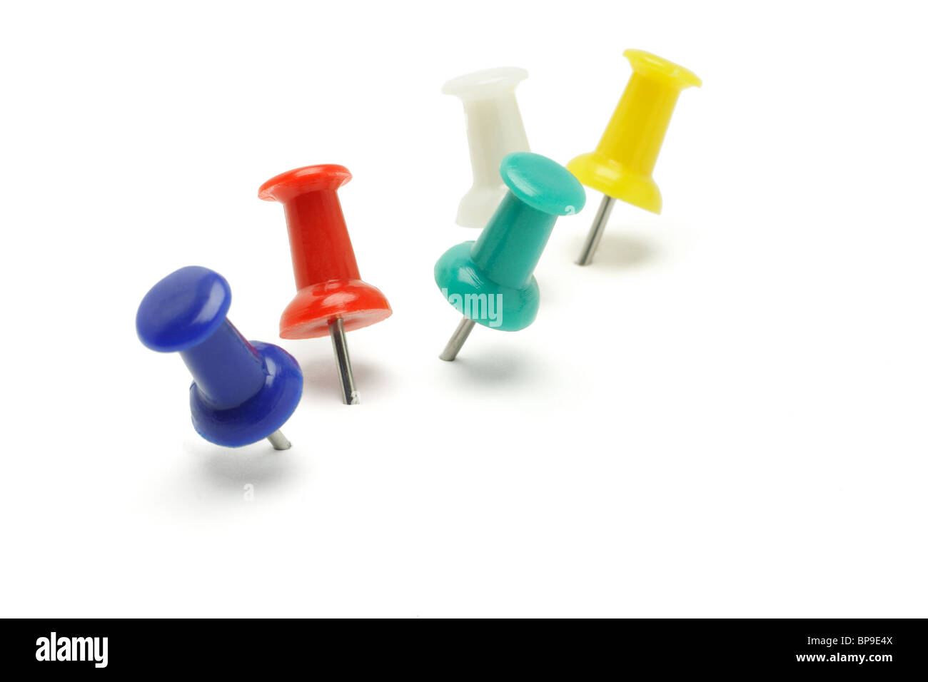 Colorful push pins arranged on white background Stock Photo