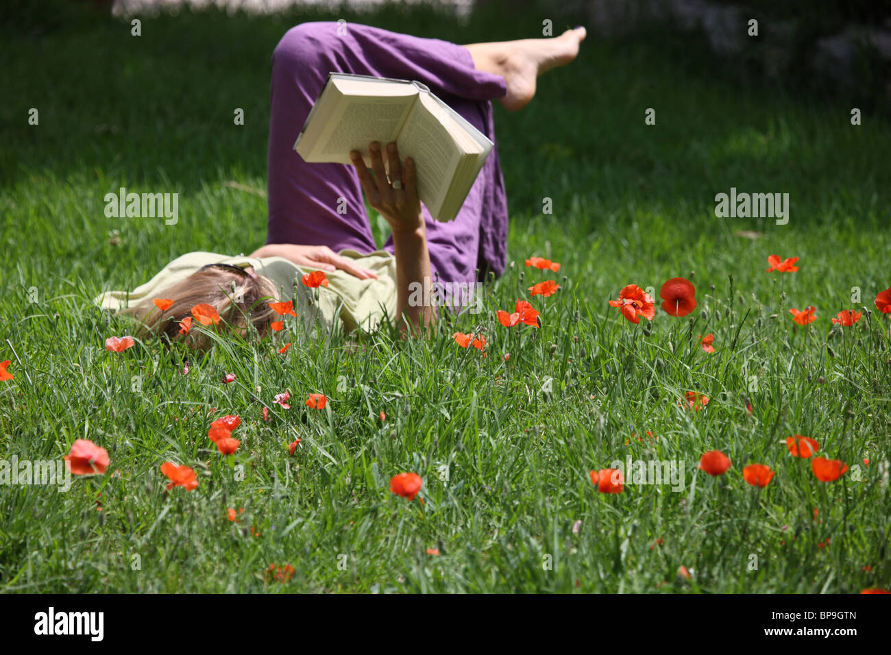 Woman relaxing in the grass Stock Photo - Alamy
