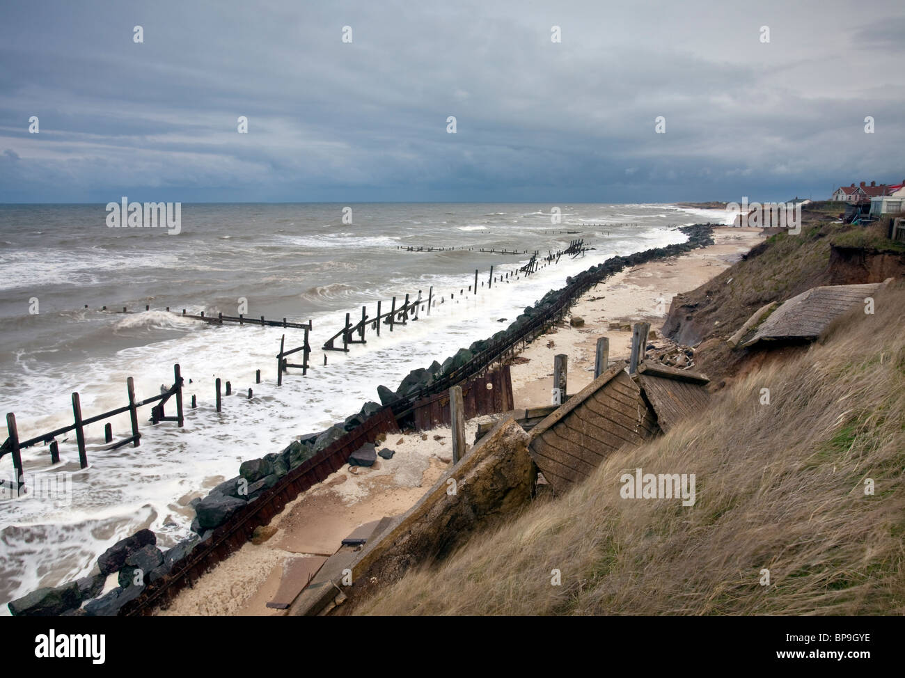 Old damaged sea defenses on the beach at Happisburgh in Norfolk Stock Photo
