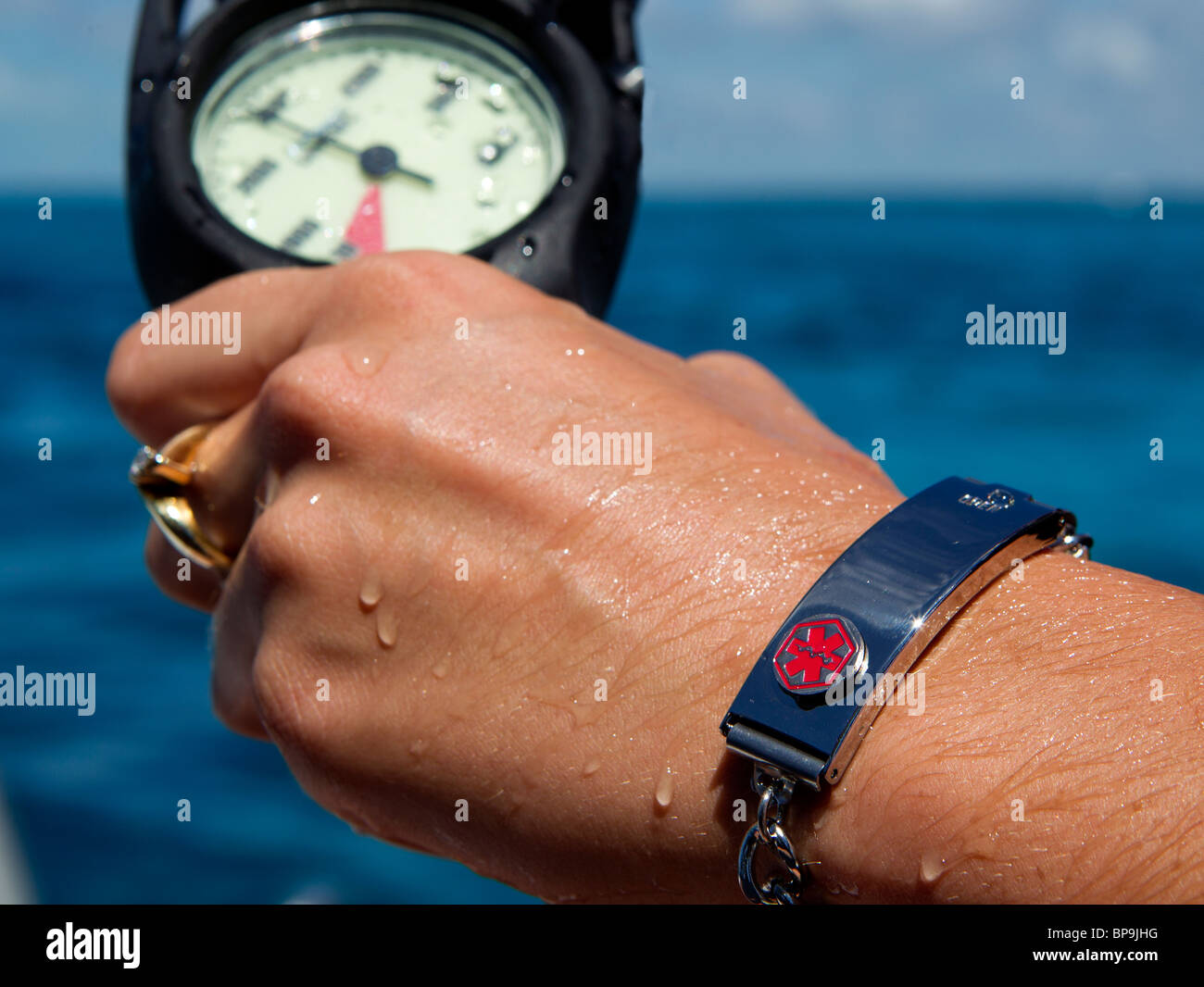 Medical bracelet on a scuba diver, indicative of diabetes Stock Photo
