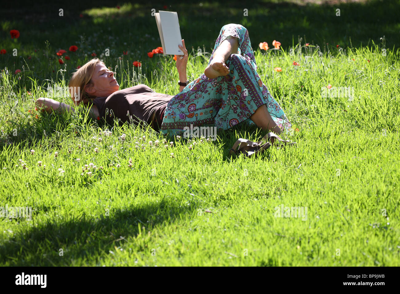 Woman relaxing in the grass Stock Photo - Alamy