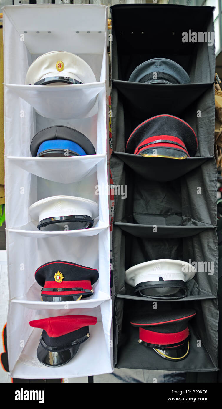 Peaked / forage / combination style military caps in a street market display Stock Photo