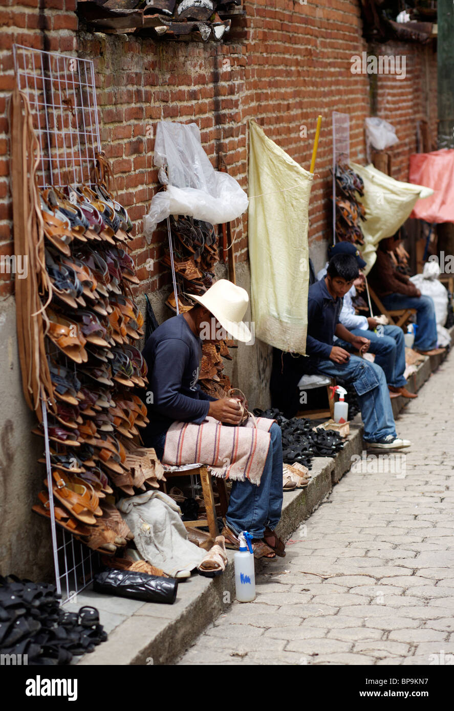 A shoemaker works at his stall in the street in San Cristobal de Las