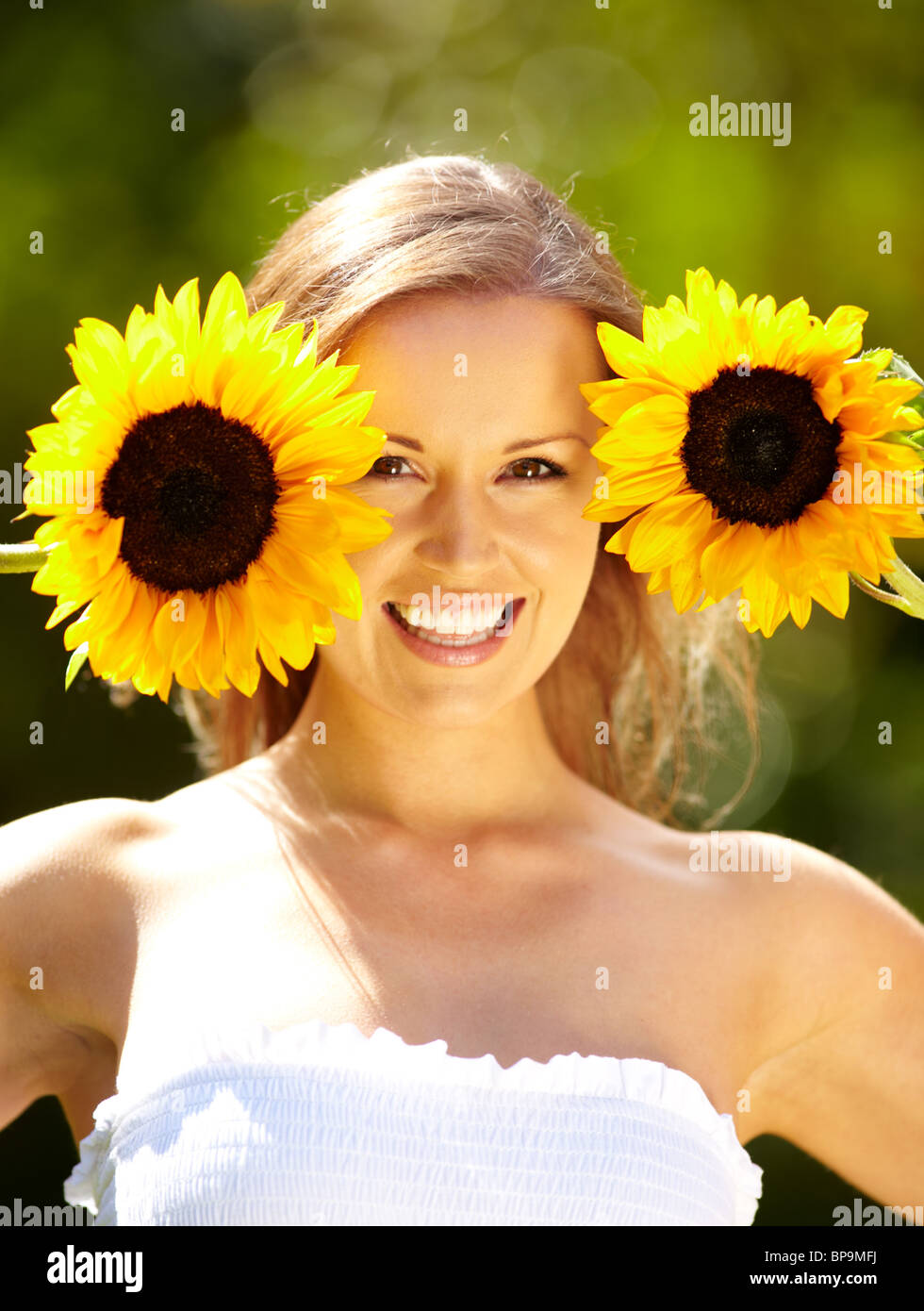 Pretty girl holding sunflower Stock Photo - Alamy